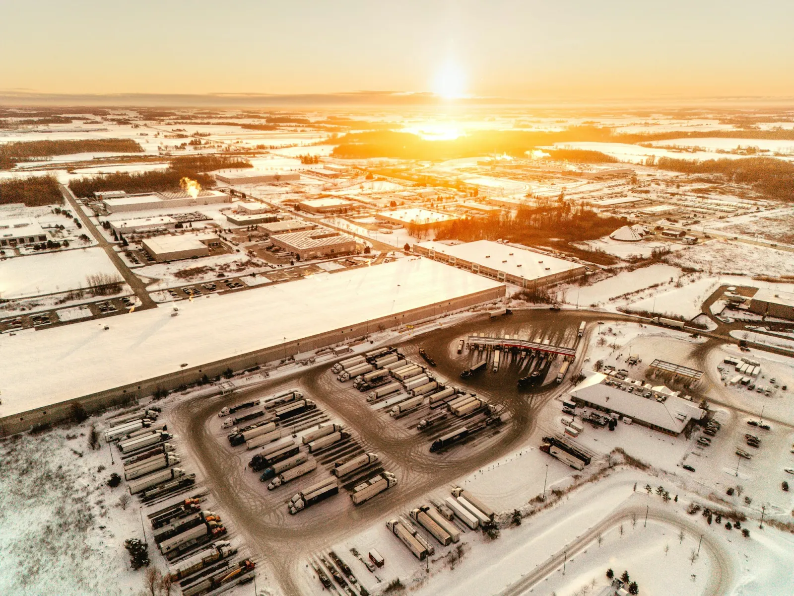 Aerial view of a large logistics park at sunset
