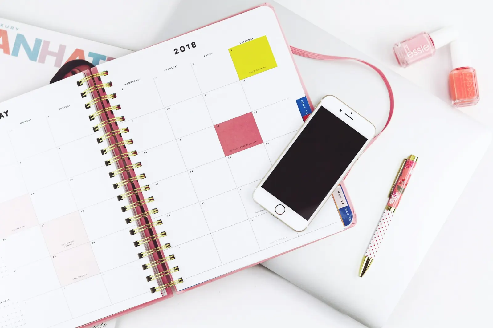 Paper planner and smartphone used to organise appointments