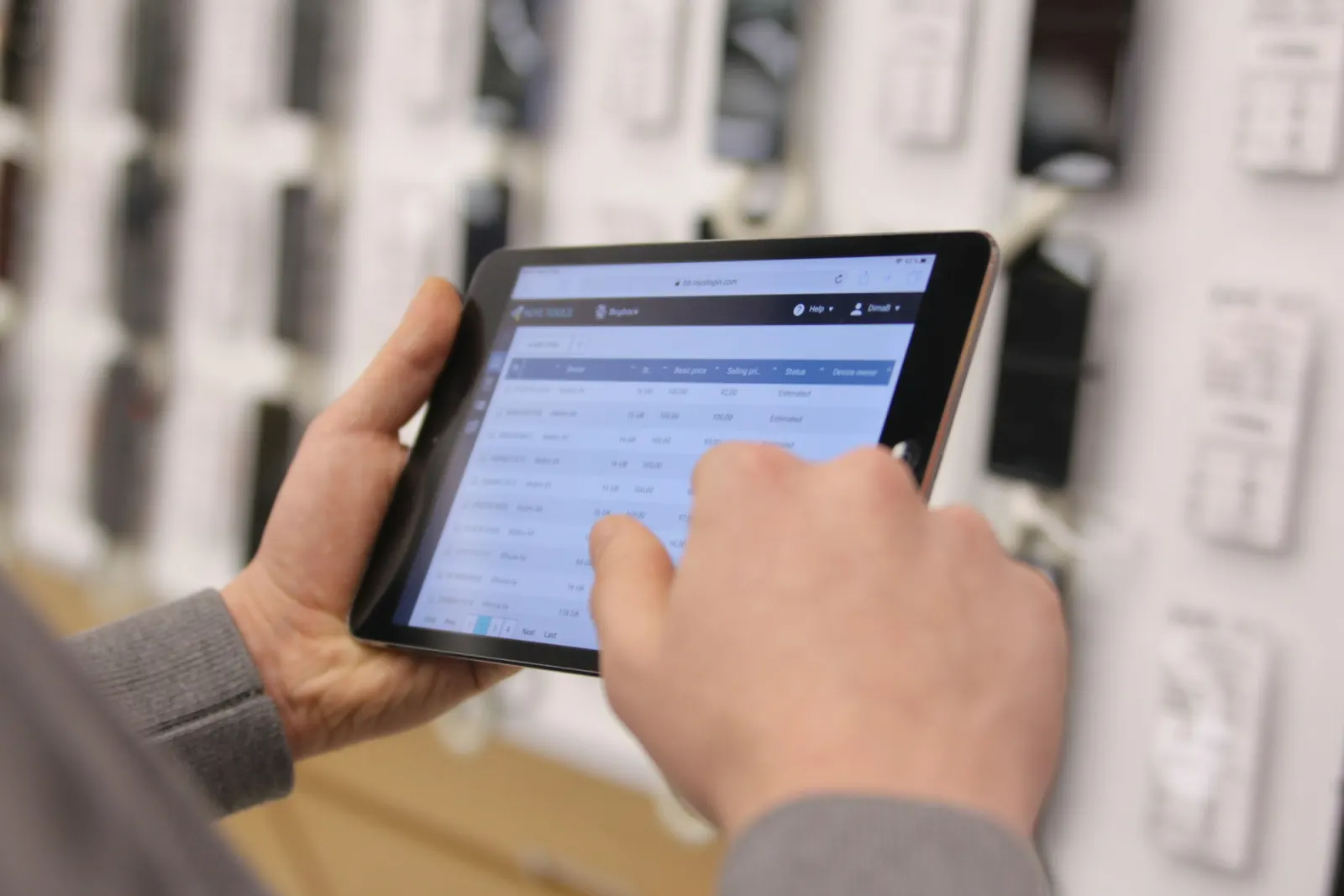 Hands using a warehouse management app on a tablet